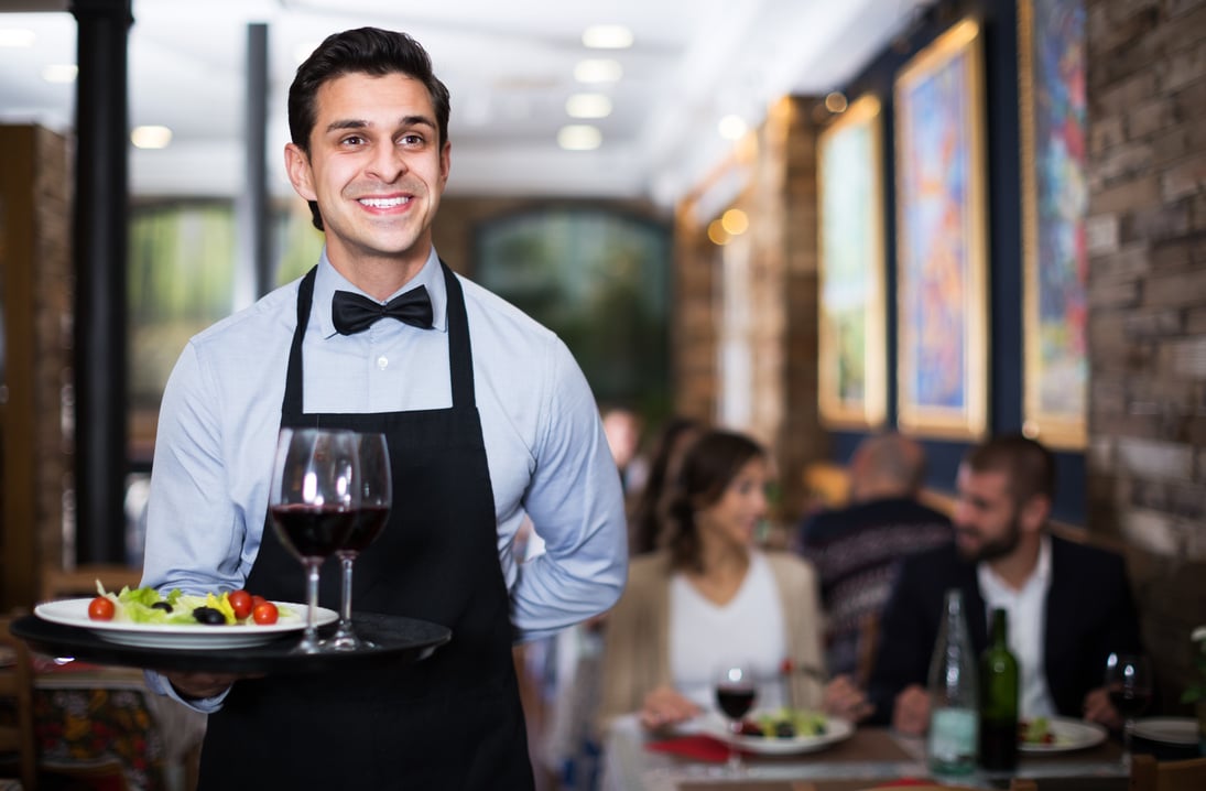 Waiter posing in restaurant